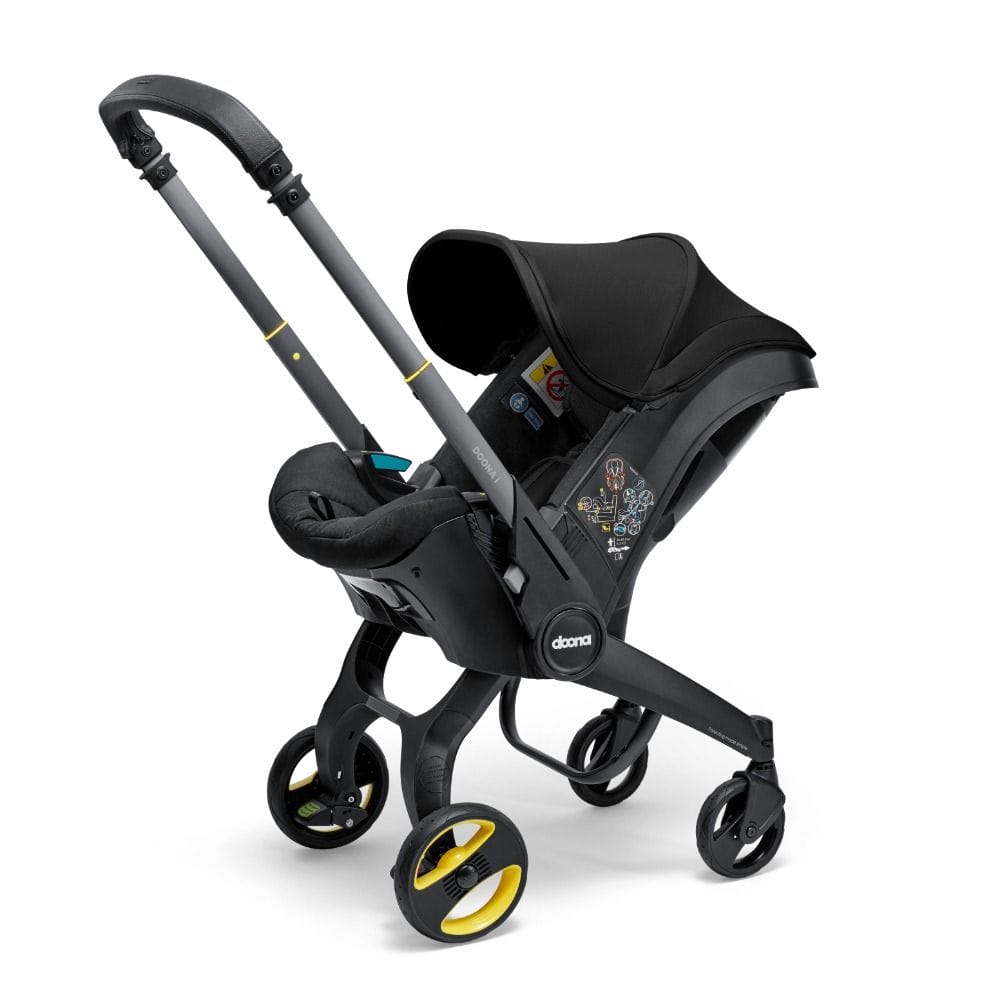 Doona I Infant Car Seat, Integrated Auto Adjust 5-Point Harness, Sleek And Ergonomic Design, Quick Release Wheels, Side Impact Protection - Nitro Black