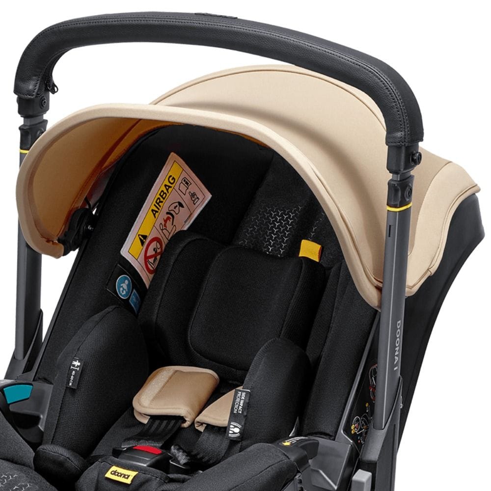 Doona I Infant Car Seat, Integrated Auto Adjust 5-Point Harness, Sleek And Ergonomic Design, Quick Release Wheels, Side Impact Protection - Sahara Sand