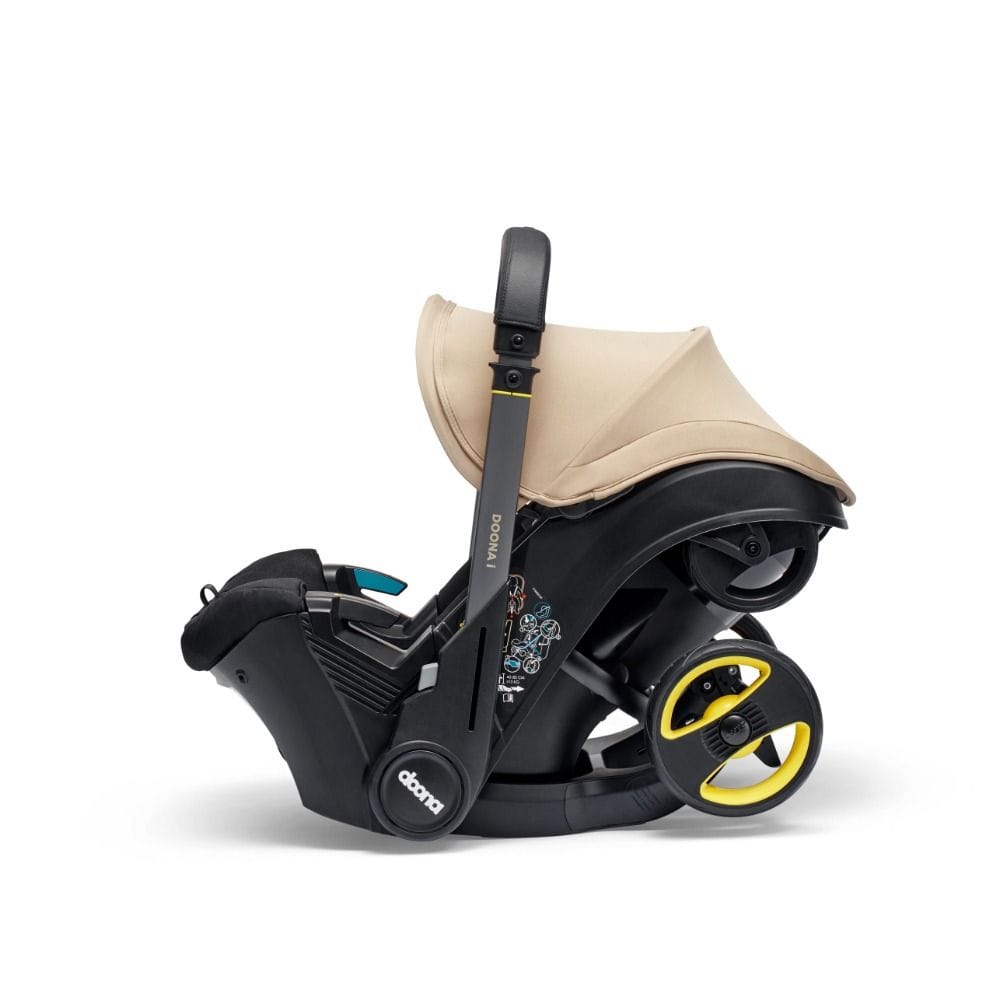 Doona I Infant Car Seat, Integrated Auto Adjust 5-Point Harness, Sleek And Ergonomic Design, Quick Release Wheels, Side Impact Protection - Sahara Sand
