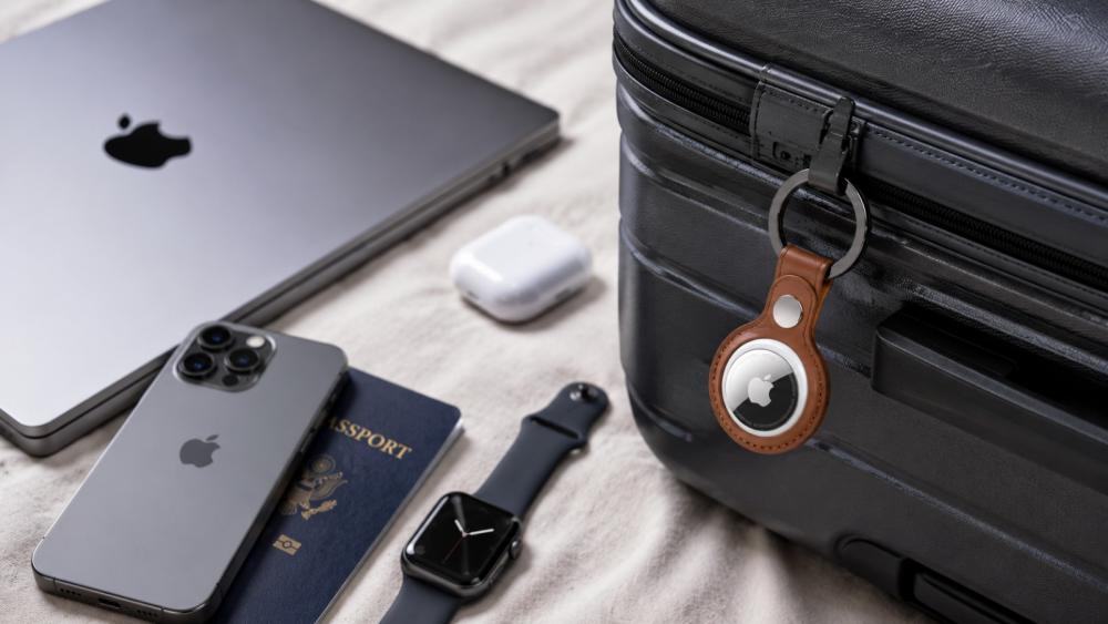 Apple AirTag attached to luggage with iPhone, Apple Watch and MacBook for travel in Qatar
