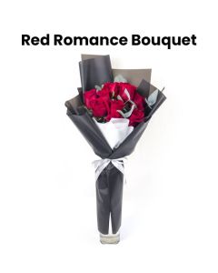 A Hand Bouquet Of Red Roses And Eucalyptus Leaves Wrapped With Black Wrapping